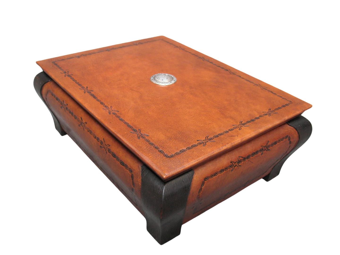 leather box with a concho design on the top and barbed wire on the side